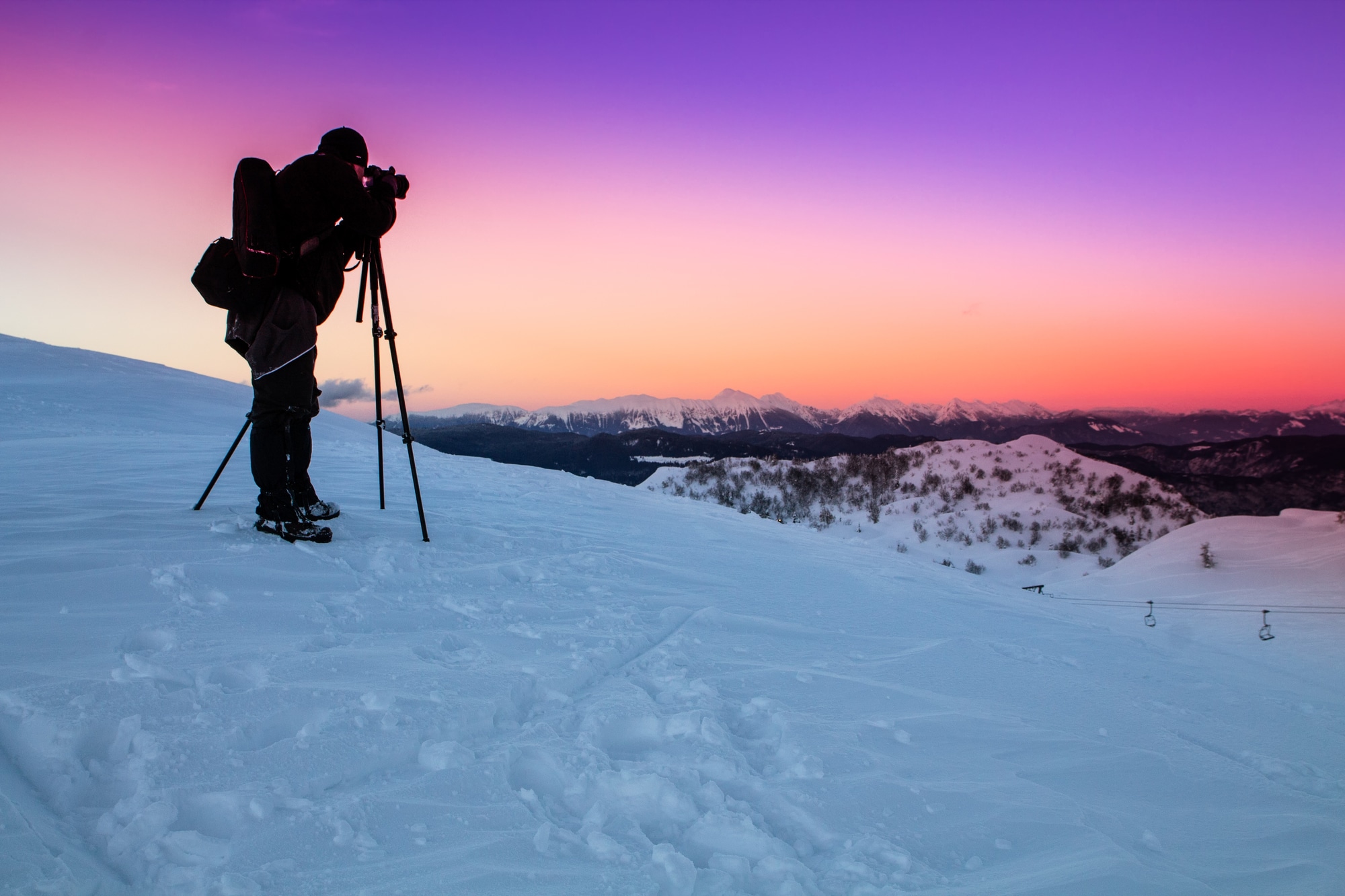 taking a picture with a tripod on a mountain