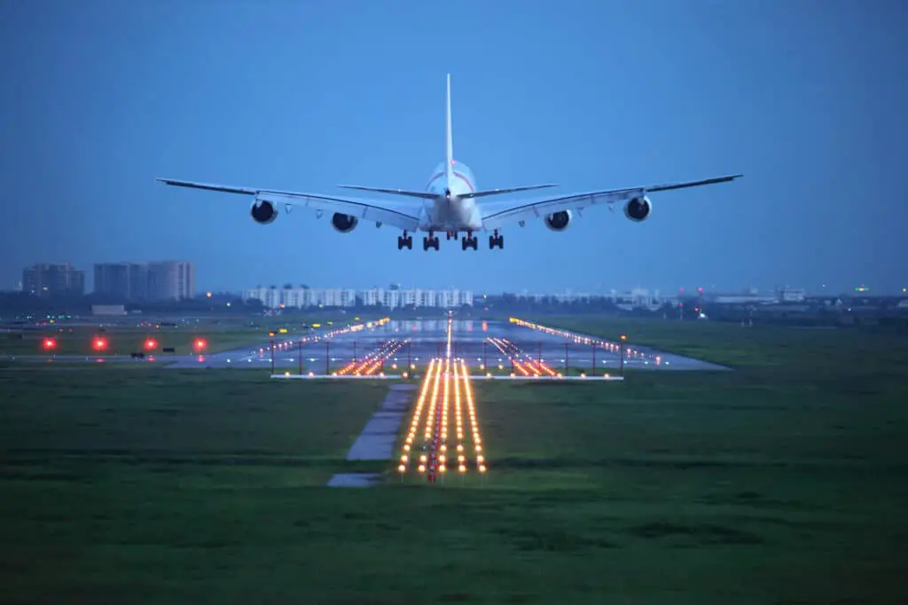 airplane landing on a runway in the evening