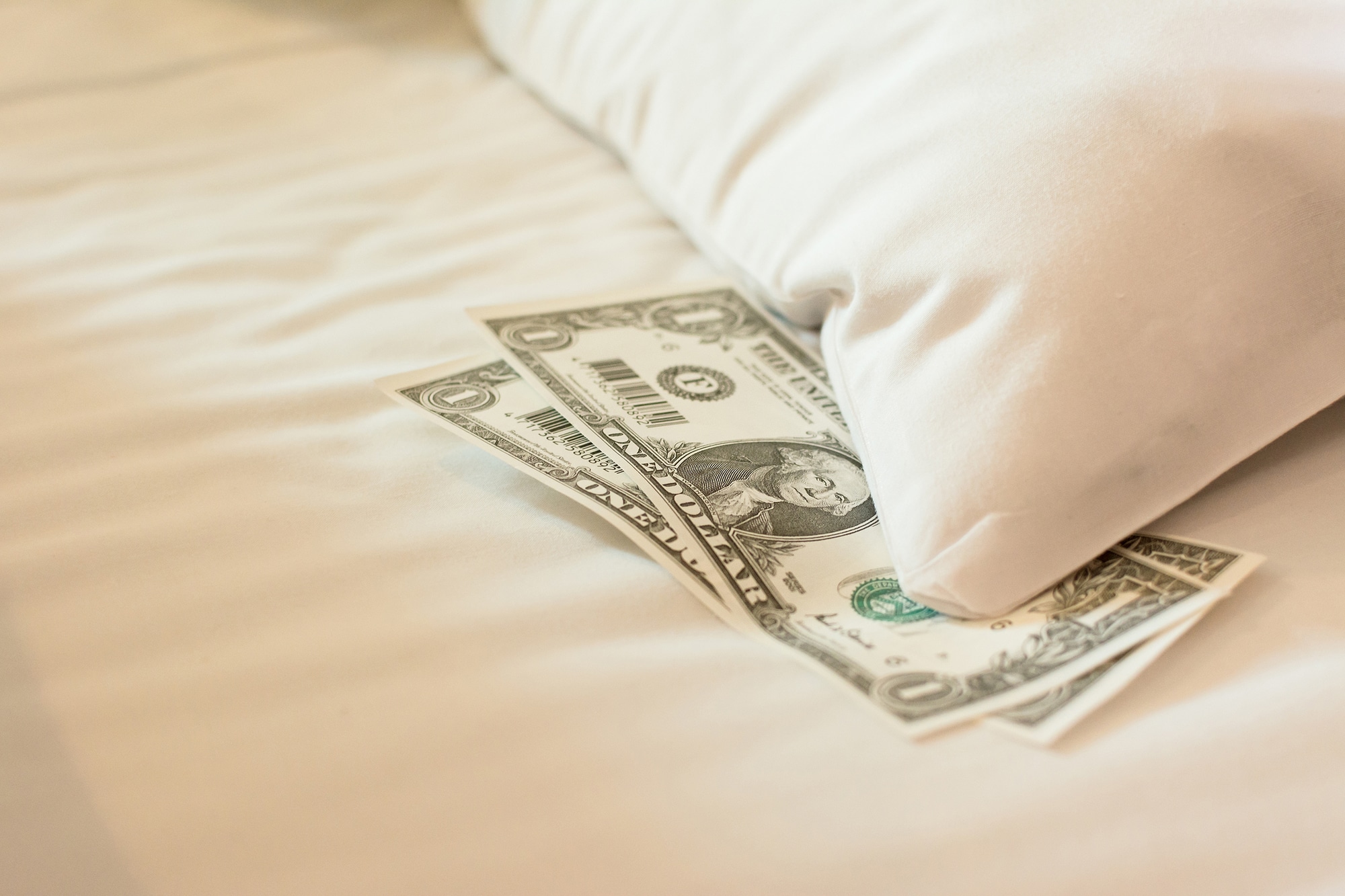 cash on the hotel bed